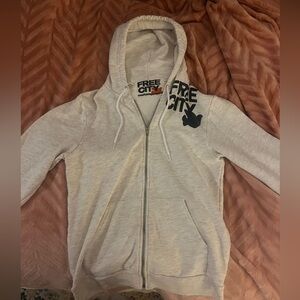 Brand New Size Small Free City Zip up, White with black lettering